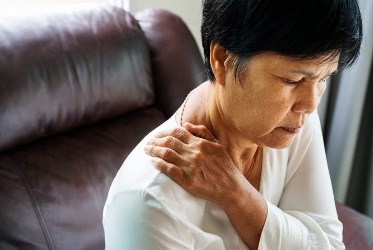 a woman holding her neck in pain