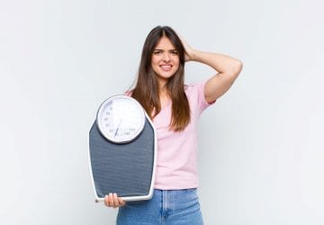 a woman holding a scale