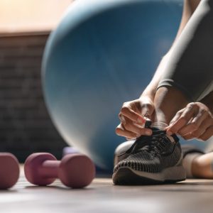 a woman putting on runners