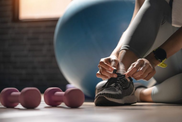 a woman putting on runners