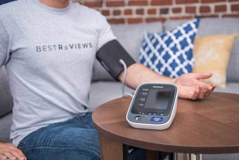 a person taking their blood pressure