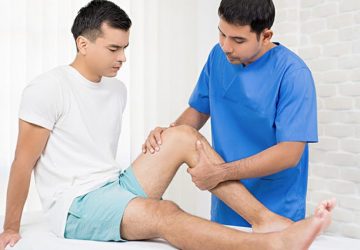 a physiotherapist working on a patient