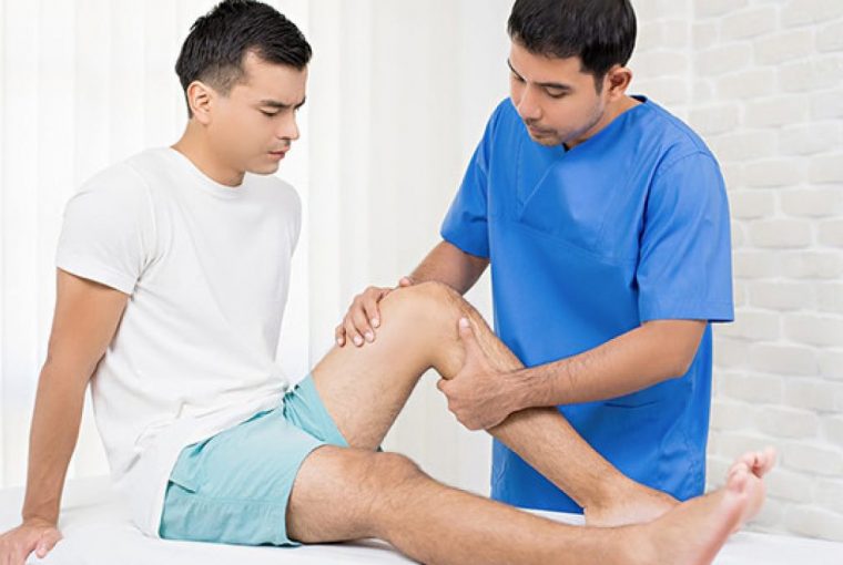a physiotherapist working on a patient