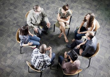 a group attending a meeting in a circle