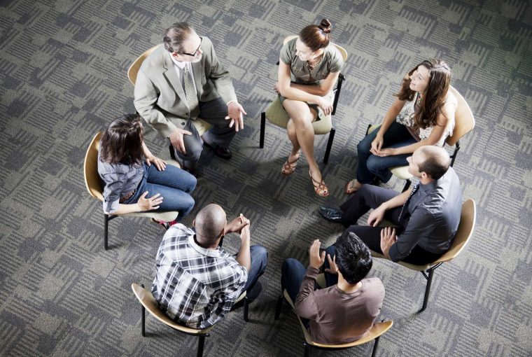 a group attending a meeting in a circle