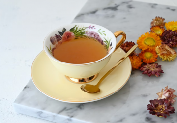 a cup of tea and bright flowers