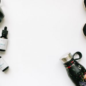 CBD [roducts on a table with running shoes