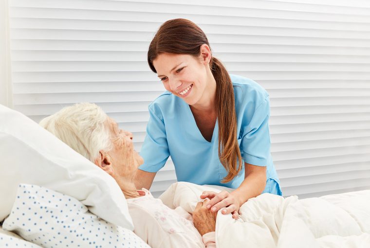 a nurse helping an elderly patient