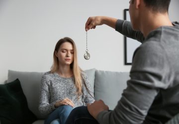 Young woman during hypnosis session in psychologist's office