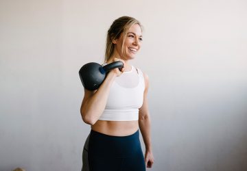 a woman exercising with a kettlebell