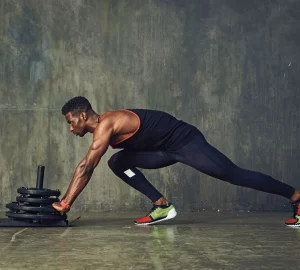 a man doing sled pushes