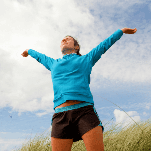 A woman with her arms raised celebrating