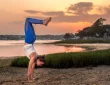 a woman doing a handstand outside