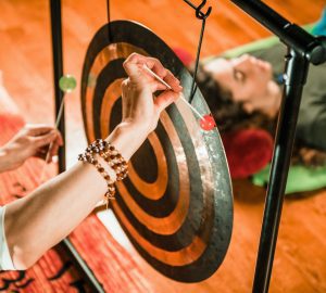 a woman hitting a gong