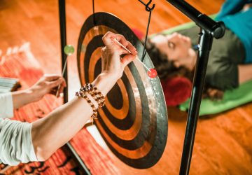a woman hitting a gong