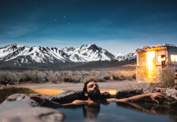 a man relaxing in a lake under a night sky