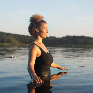 a woman in a lake getting ready to swim