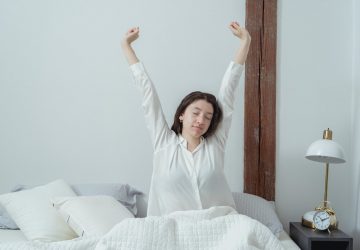a woman stretching after waking up