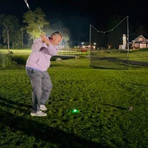 a man playing night golf