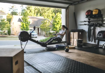 a woman in her garage on a rowing machine