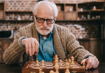 a senior man playing chess
