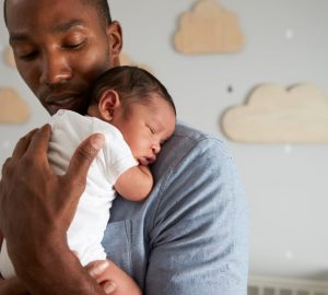 a man holding his new baby