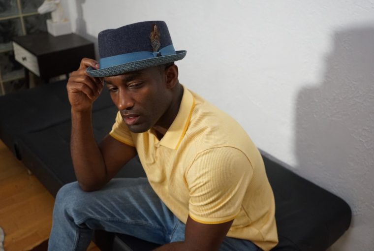 a man wearing a fedora hat