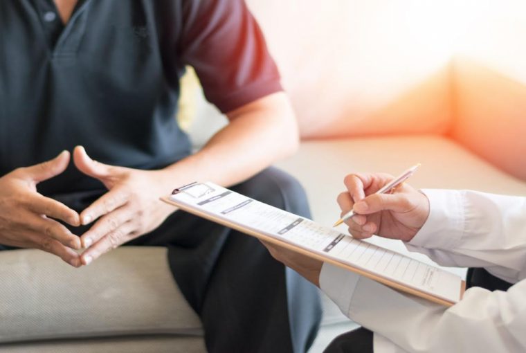 a man sitting with their doctor