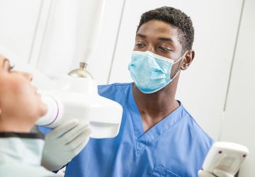 a dental assistant working on a patient