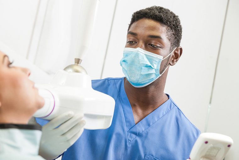a dental assistant working on a patient