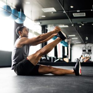 a man stretching at the gym
