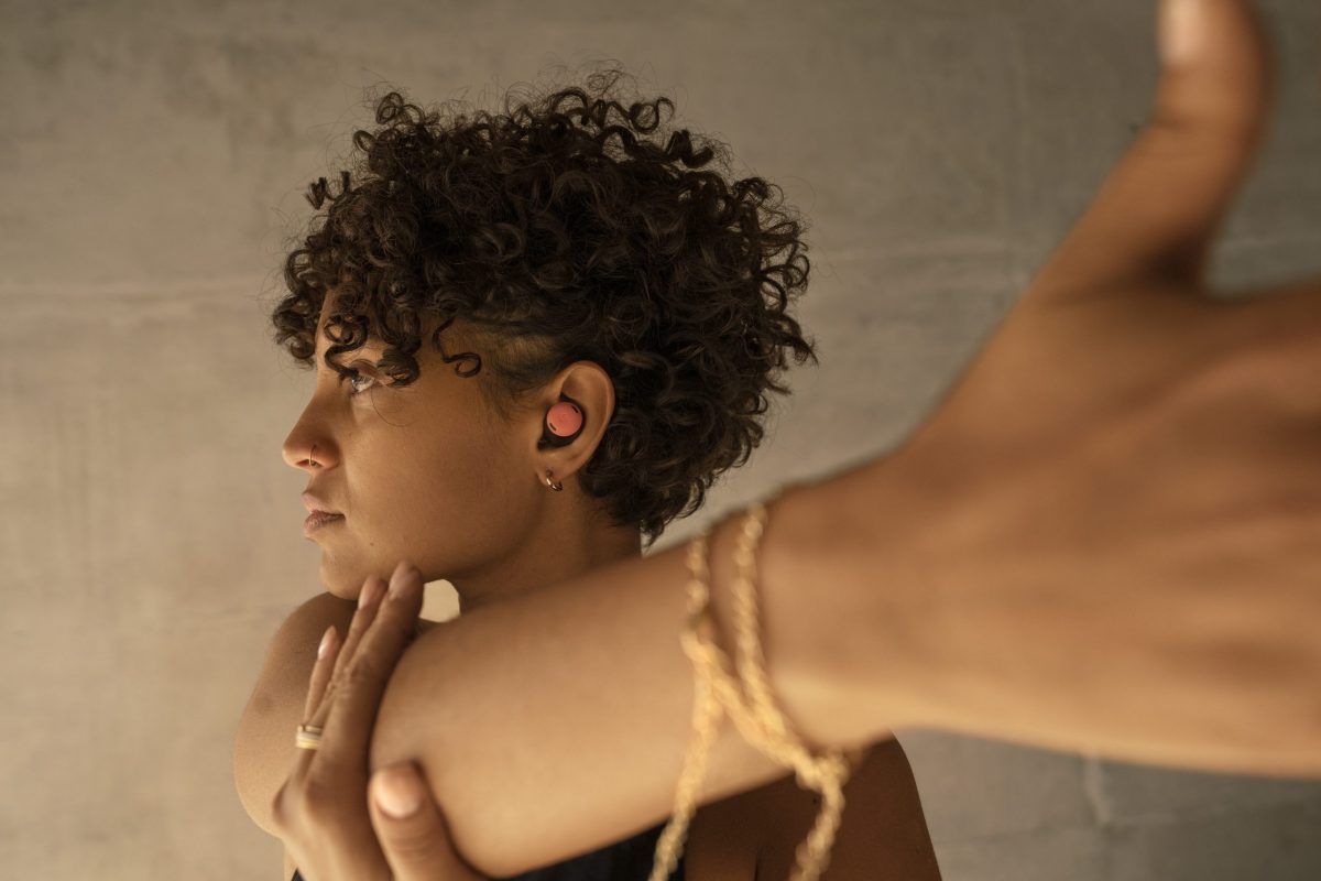 a woman stretching listening to music in her earbuds