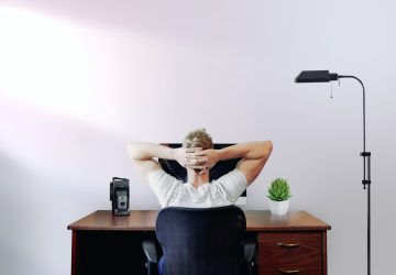 a man sitting at his desk relaxing