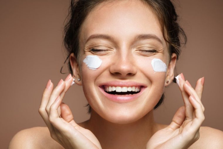 a woman applying face cream