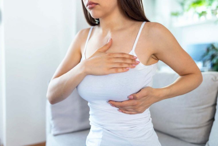 a woman checking her breast
