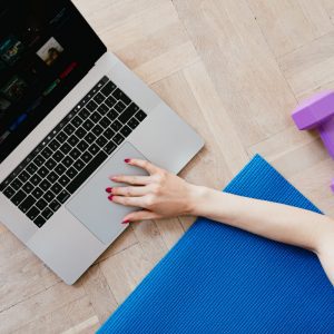 a woman typing on a computer and exercising