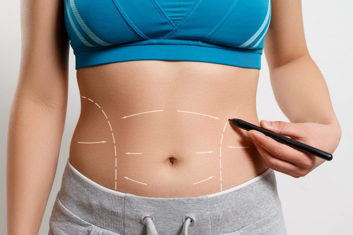 a woman drawing on her abdomen