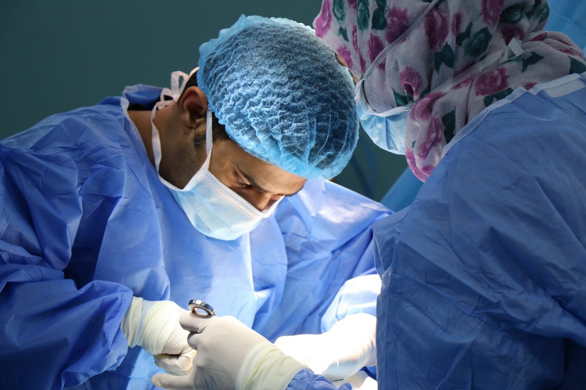 a surgeon working on a patient