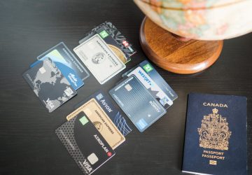 an assortment of credit cards beside a Canadian passport