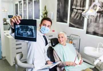 a woman with her dentist looking at an x-ray