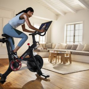 a woman doing spin in her living room