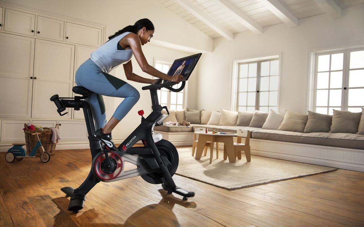 a woman doing spin in her living room