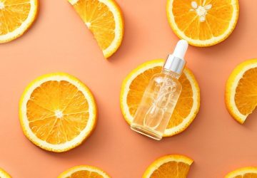a serum against a backdrop of oranges