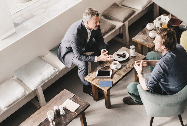 Businessman consulting customer in cafe