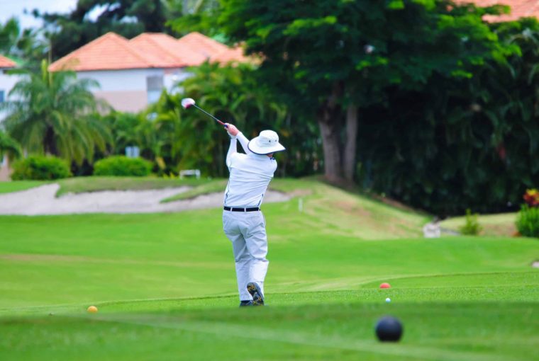 a man golfing near vacation homes