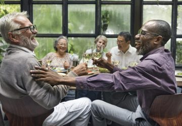a group of seniors laughing around a table
