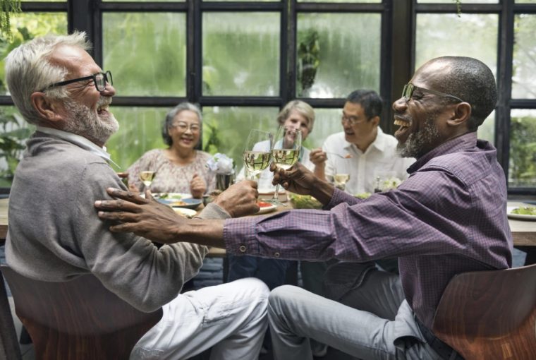a group of seniors laughing around a table