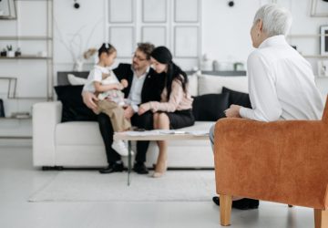 a family sitting with a counsellor