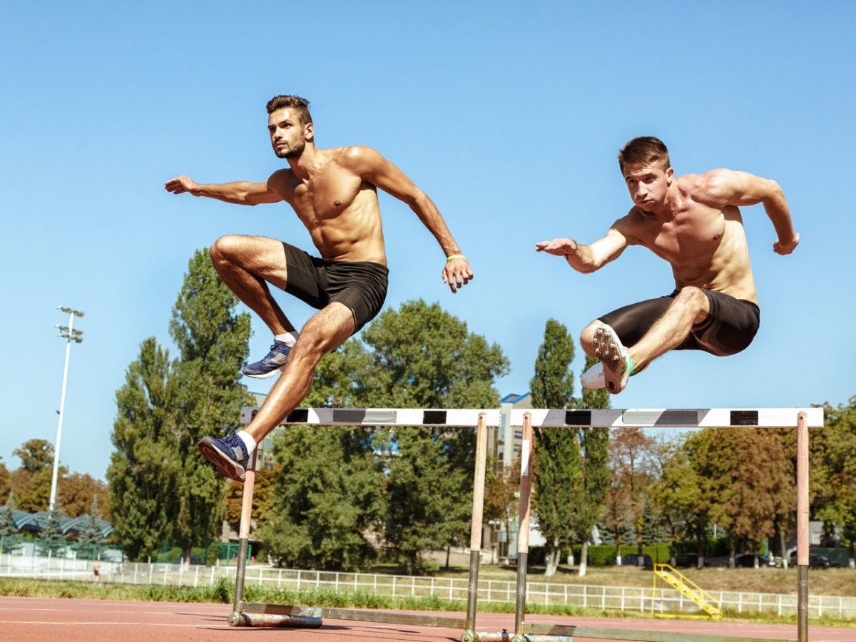 2 men doing hurdles outdoors
