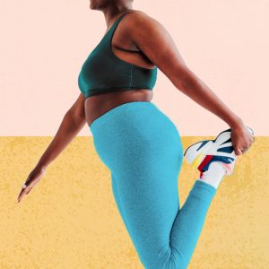 a woman stretching her legs as she prepares for a workout